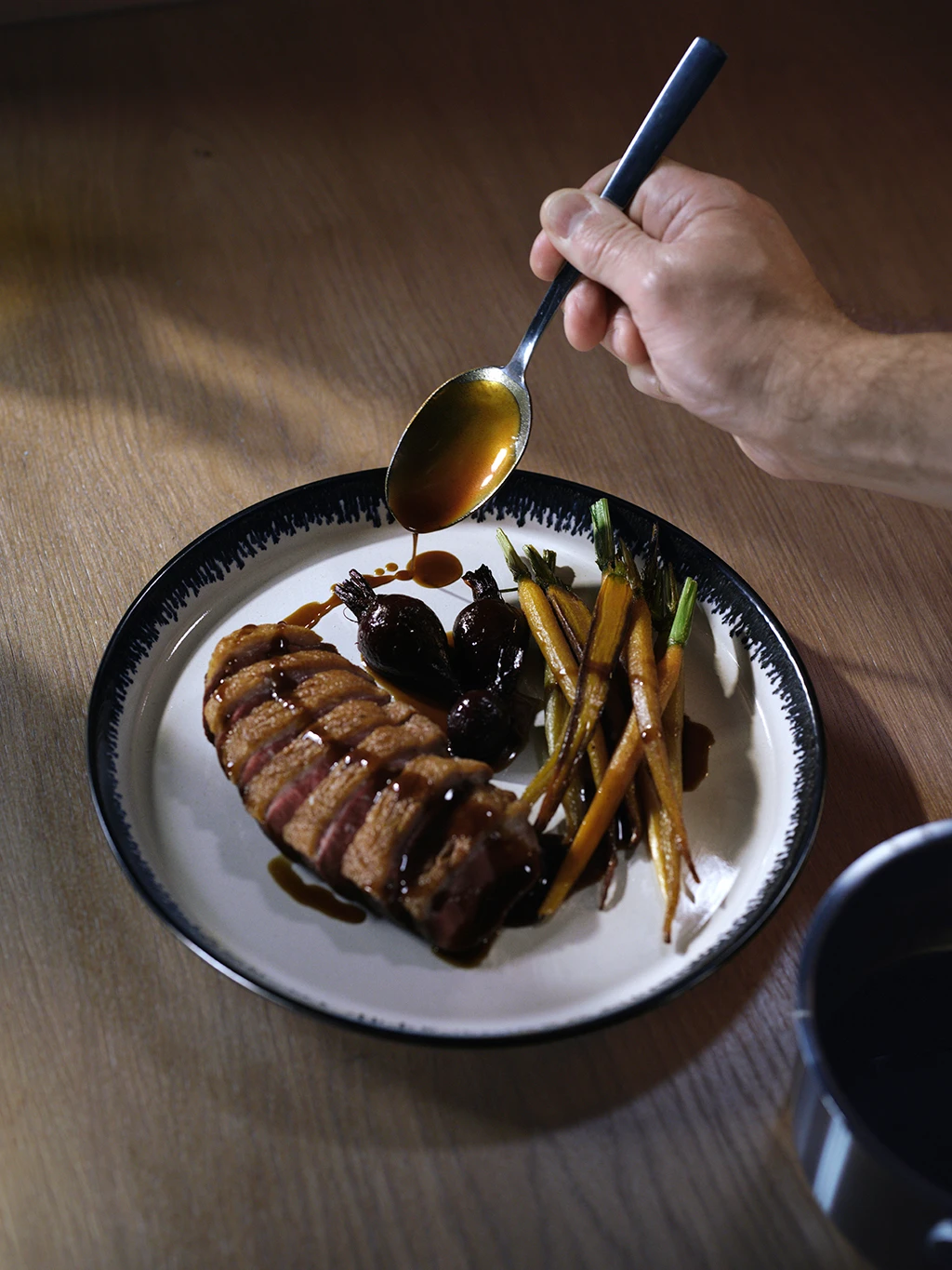 Tom Kerridge dressing a dish