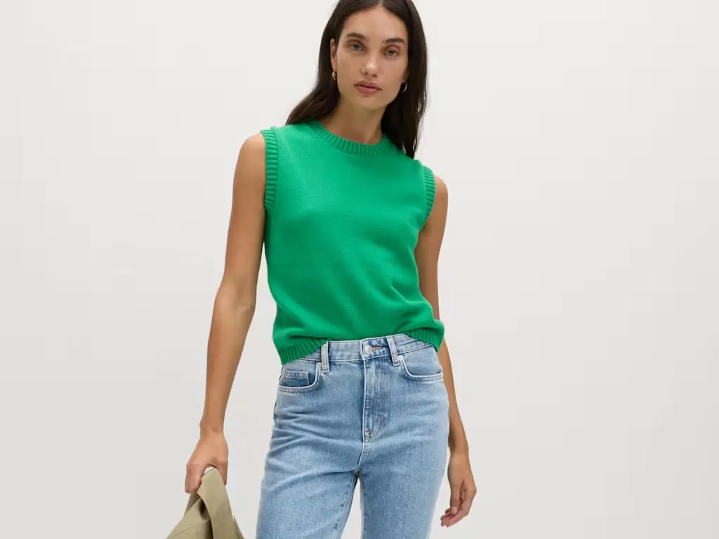 Woman in green top and light jeans