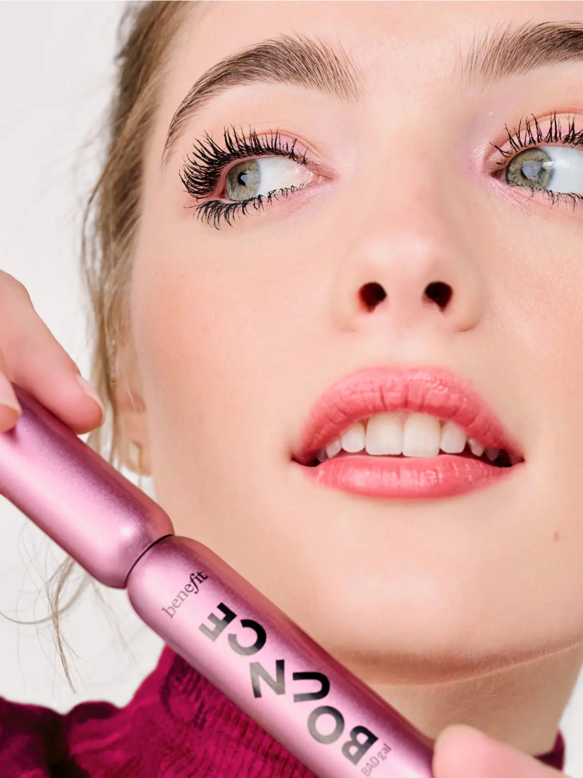 Woman holding pink mascara 
