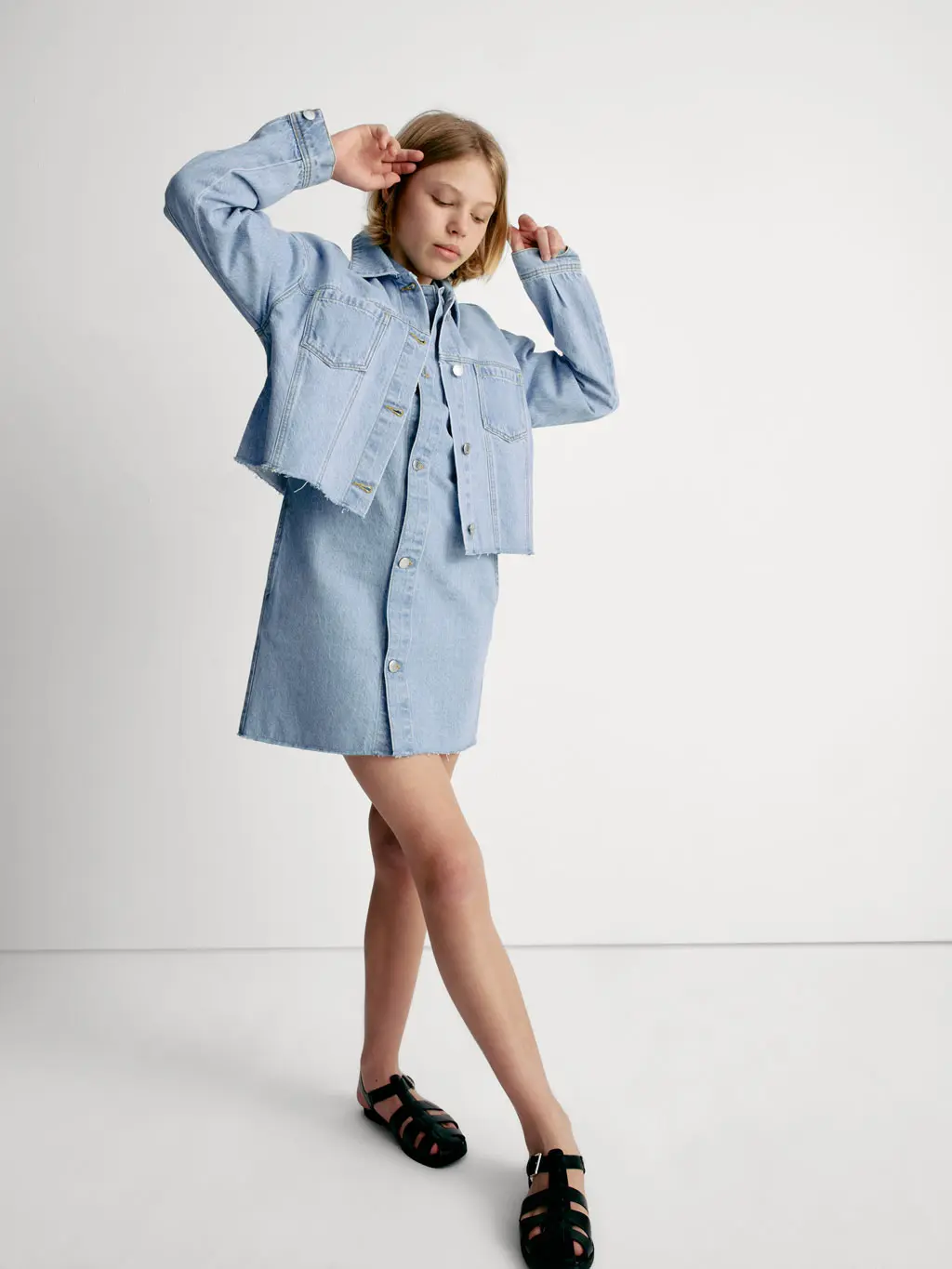 Child wearing a denim shirt and dress