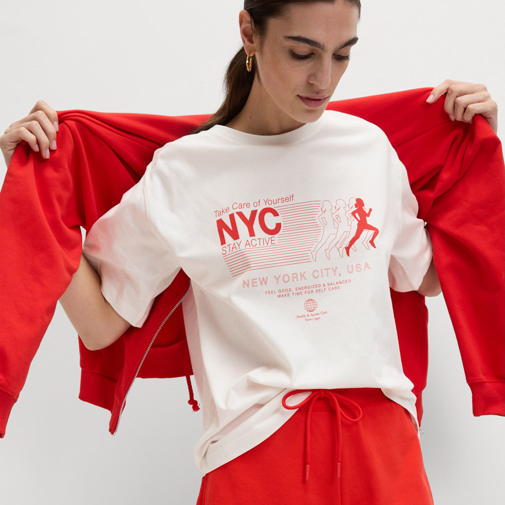 Woman wearing a white graphic T-shirt with red shorts