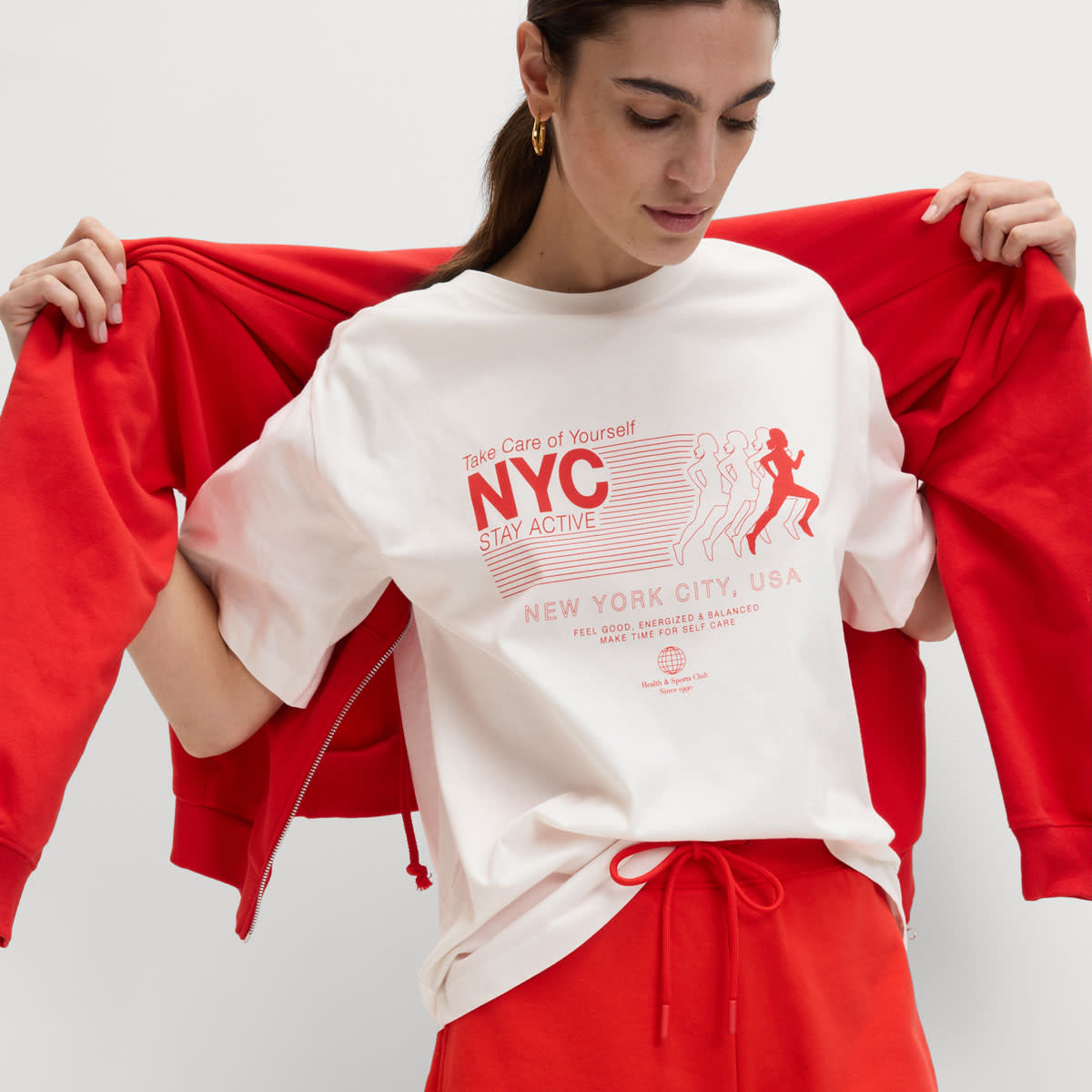 Woman wearing a white graphic T-shirt with red shorts