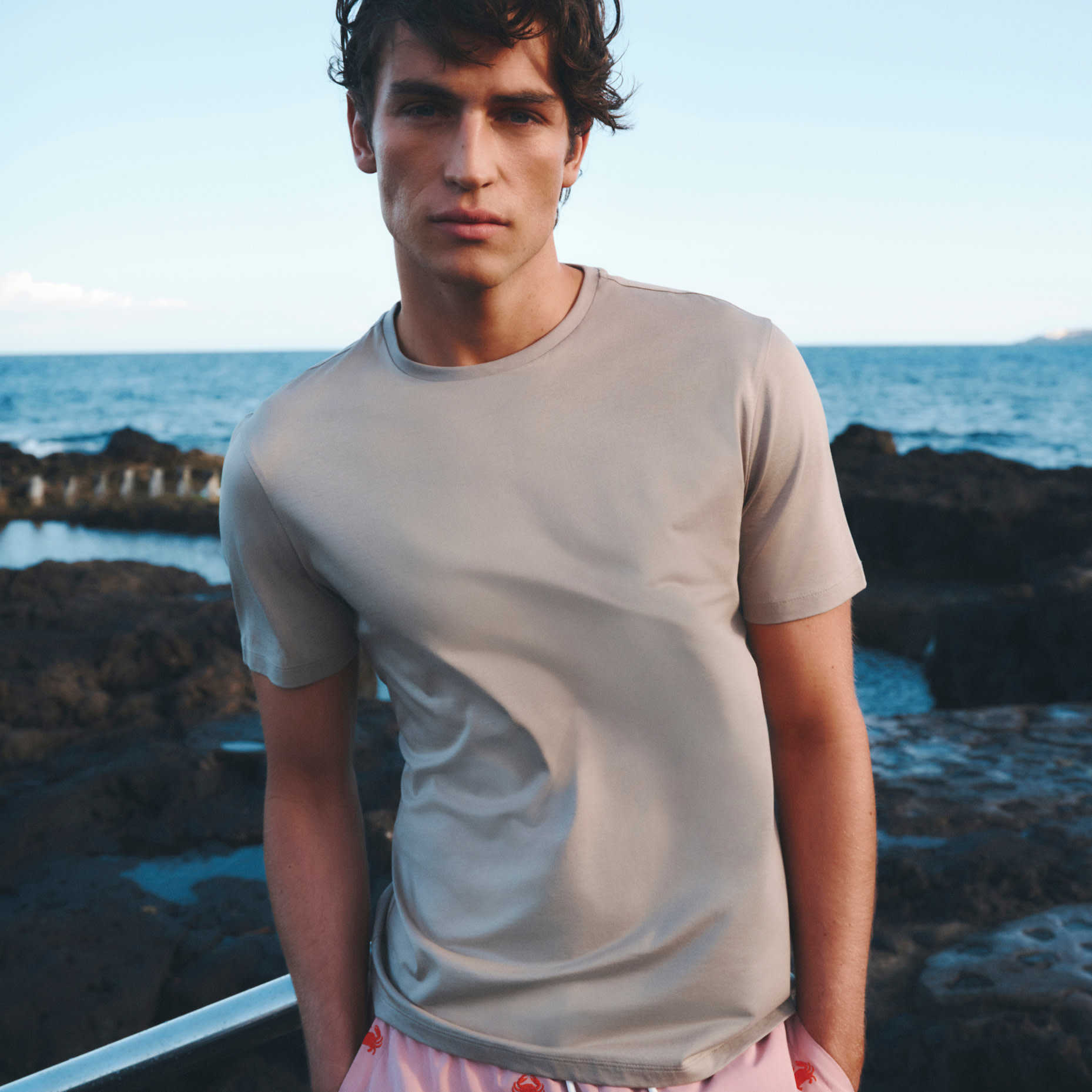 Man wearing a gray top T-shirt. 