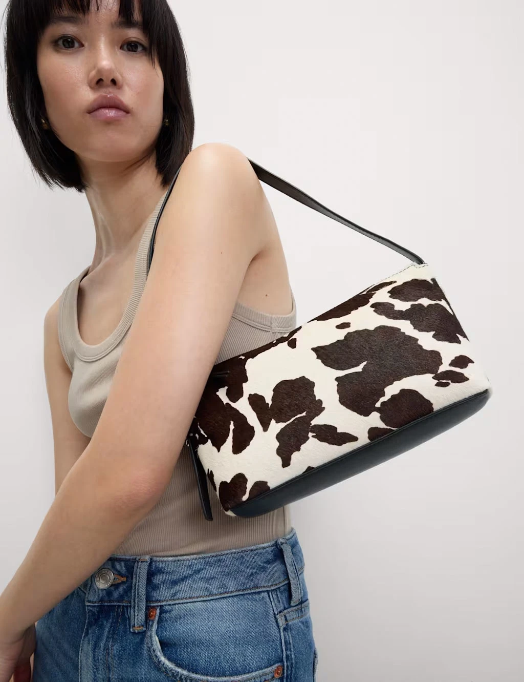Woman with cow-print noughties-style shoulder bag