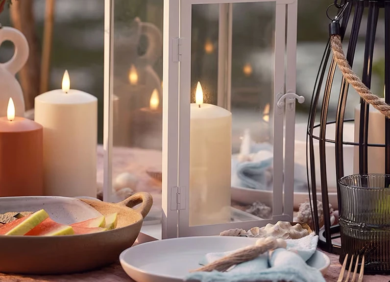 Table set with candles, lanterns and assorted crockery