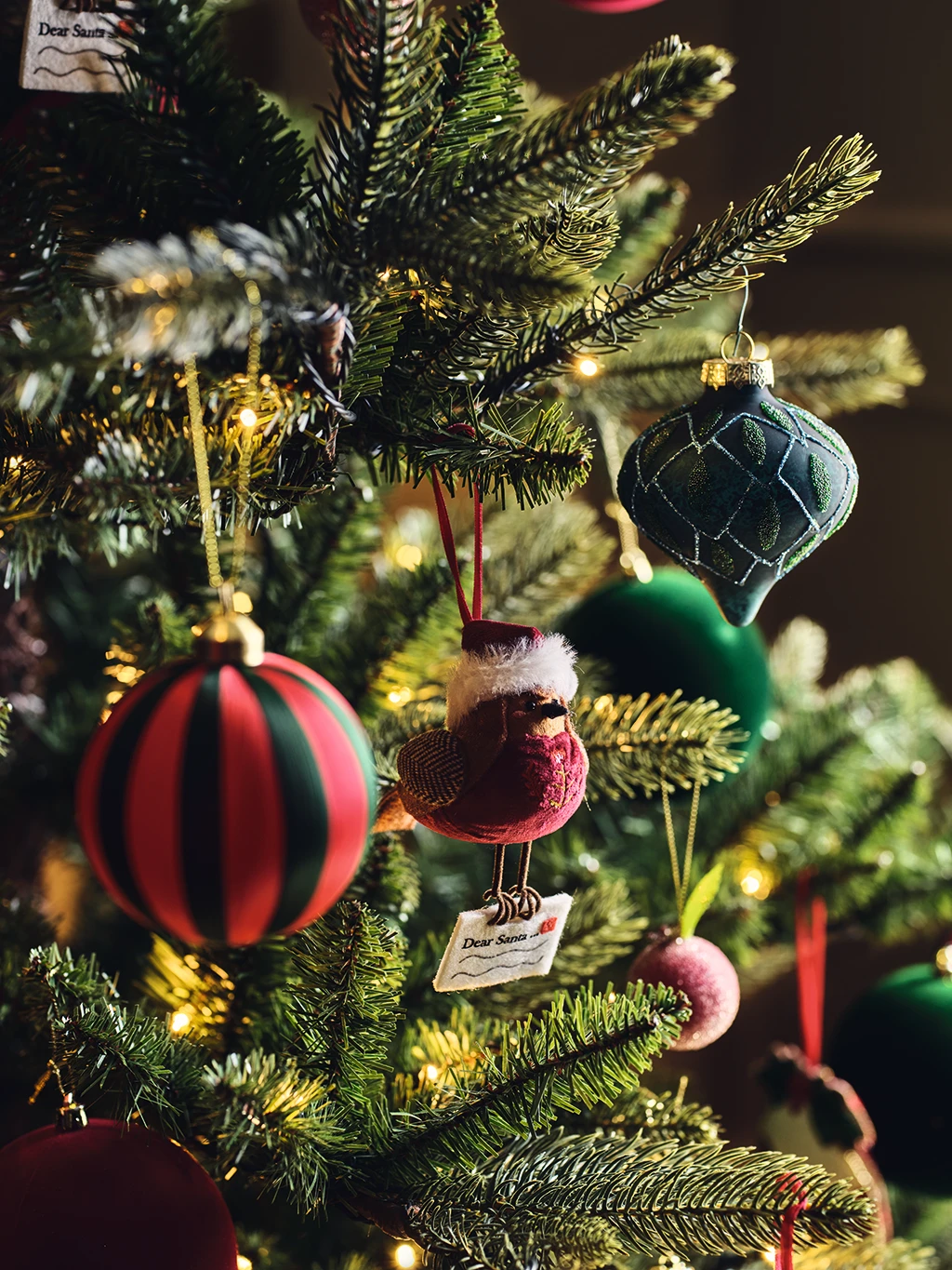 Assorted baubles hanging on a Christmas tree