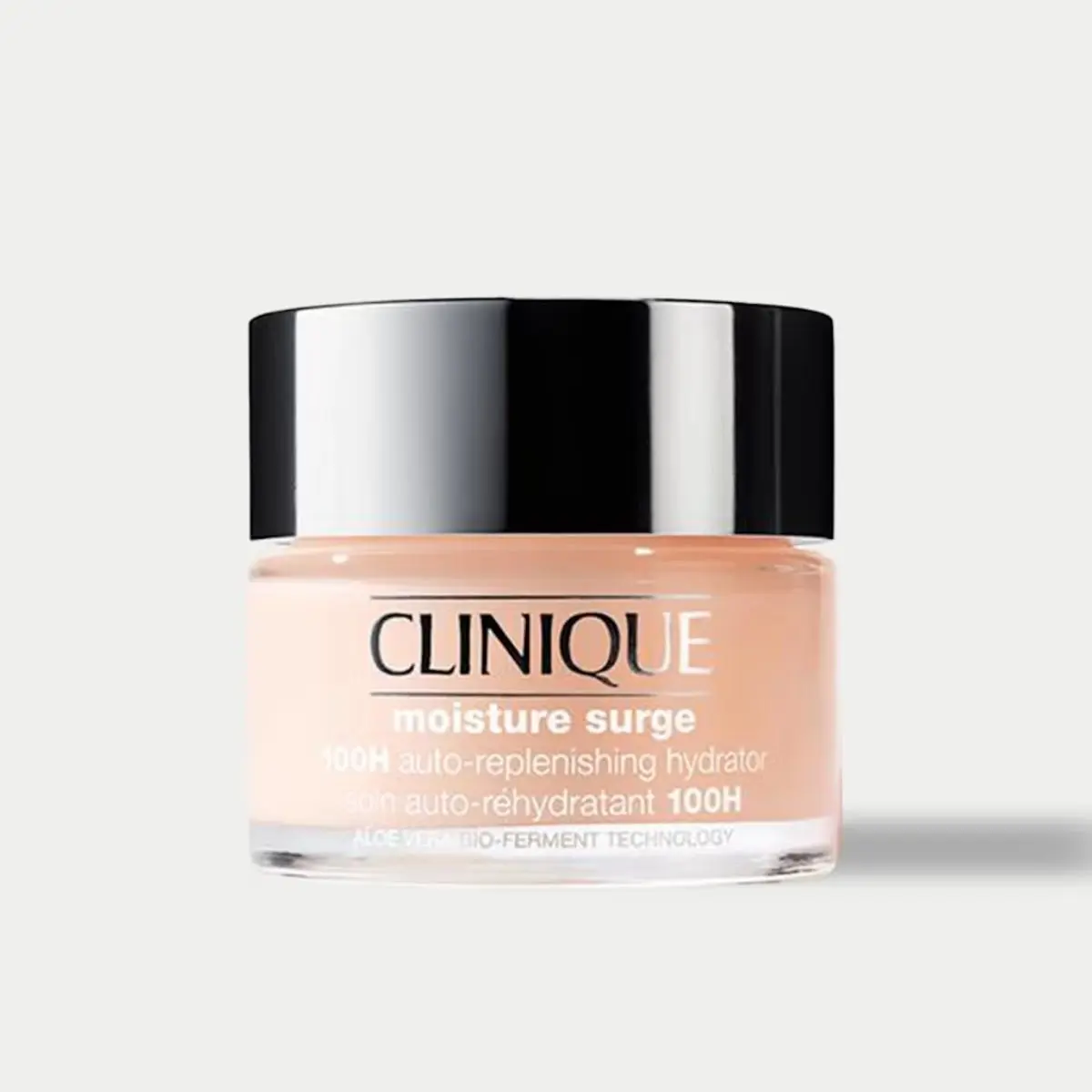 A jar of Clinique moisture surge moisturiser sat against a pale background