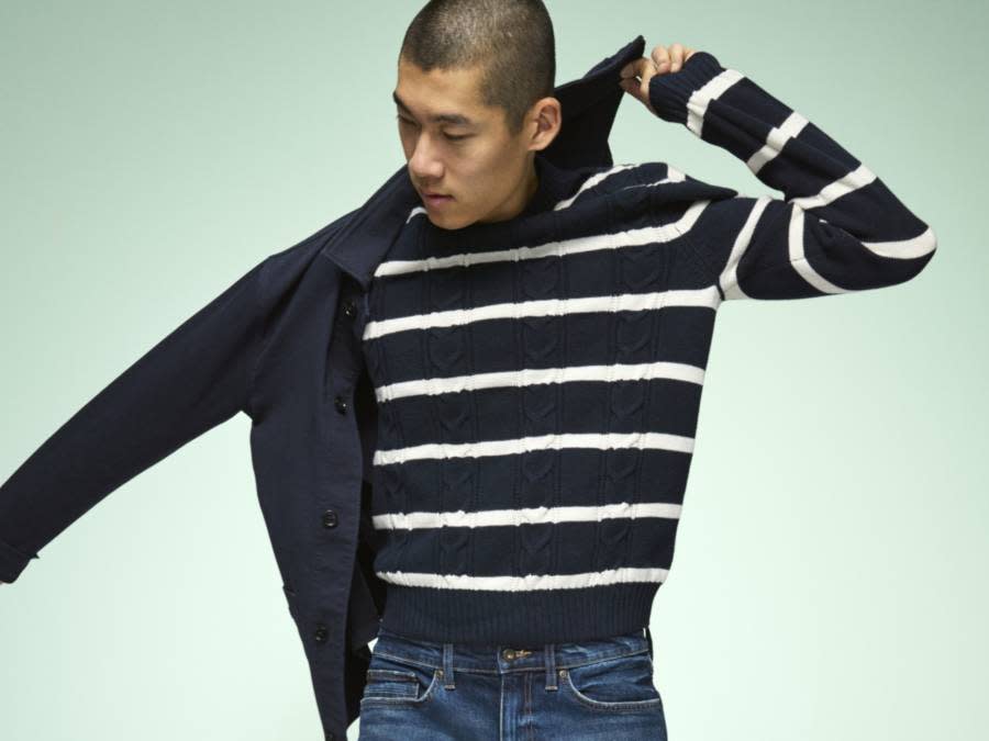 Man wearing navy and white stripe jumper. Shop knitwear