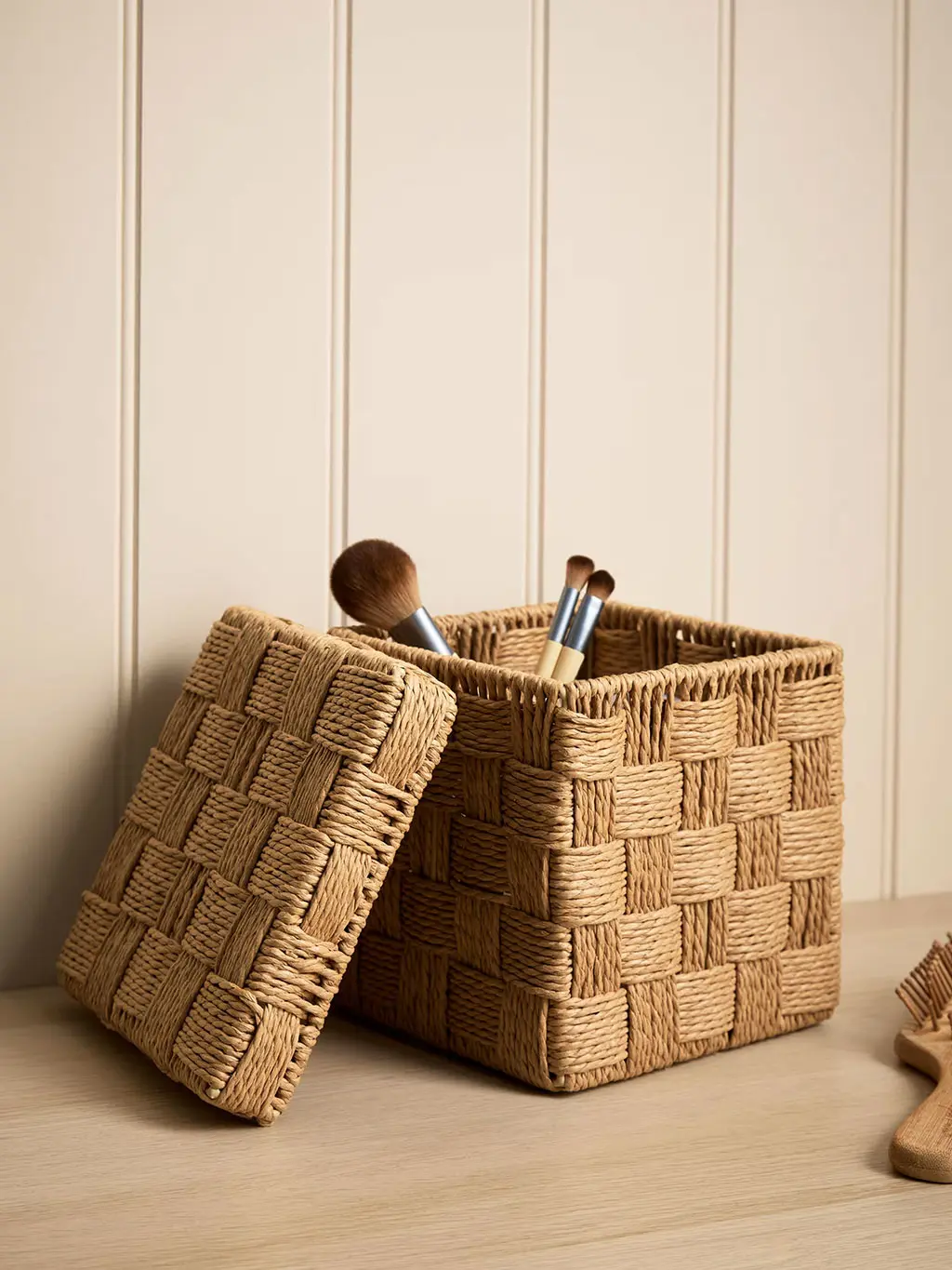Storage basket with make-up brushes in it
