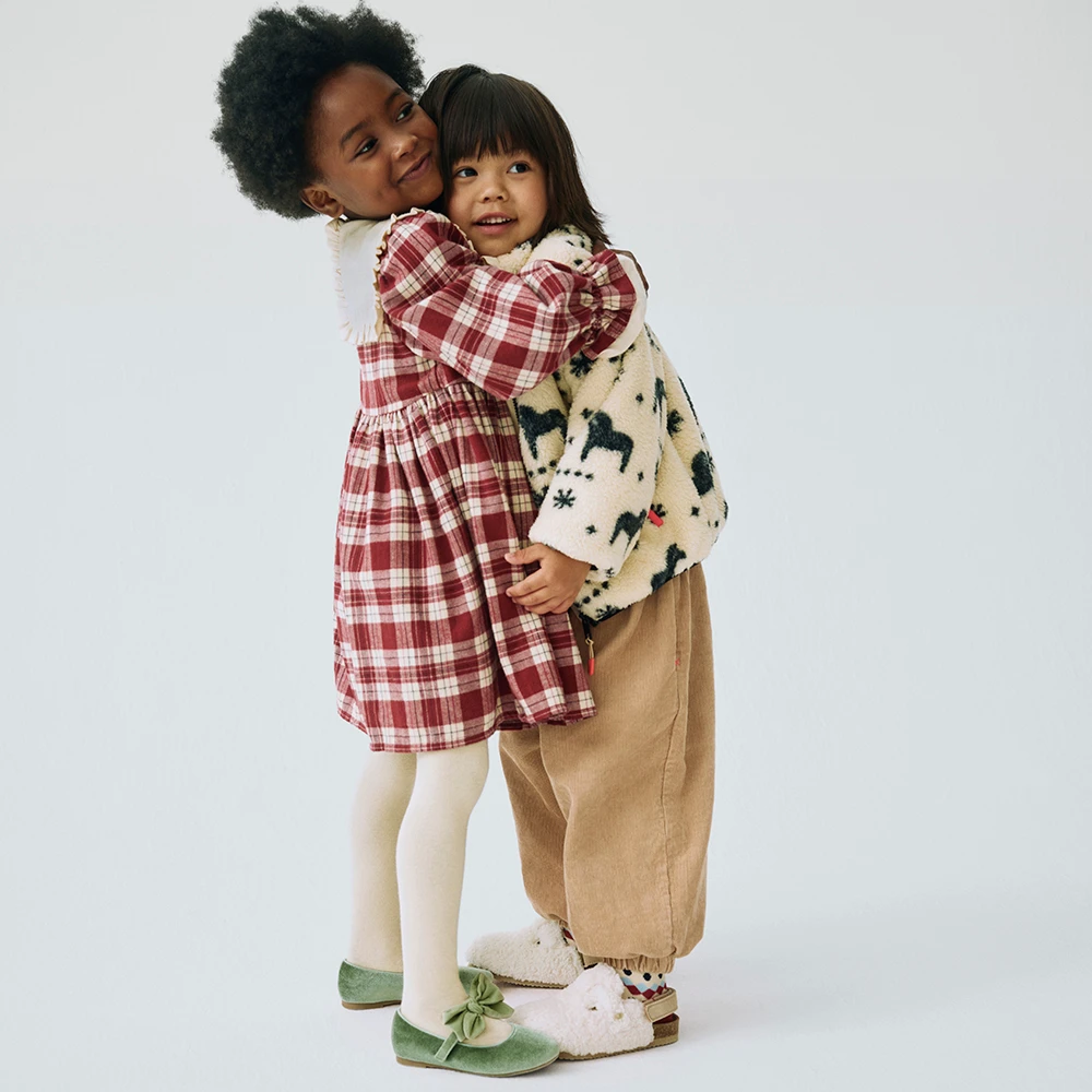 Two children hugging wearing M&S x Binky outfits