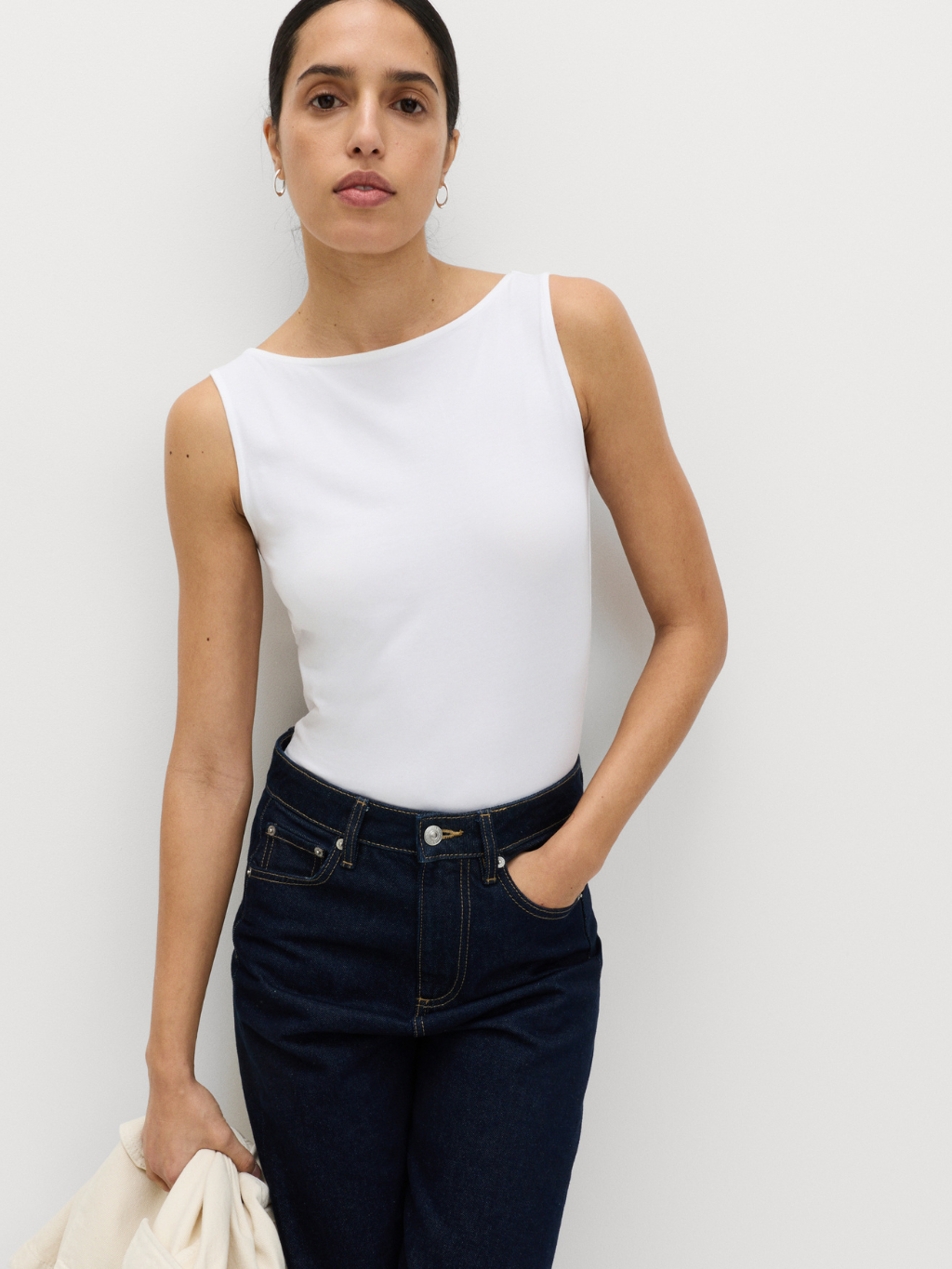 Woman wearing sleek white bodysuit