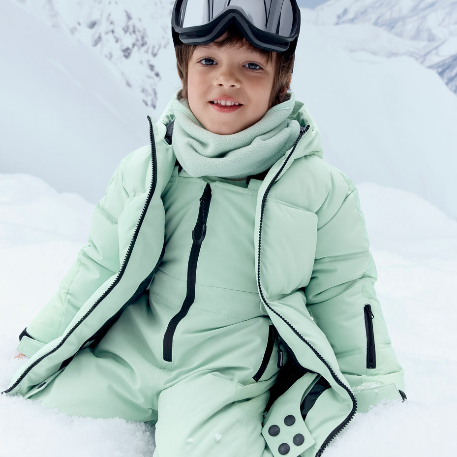 Woman holding a pair of white ski gloves