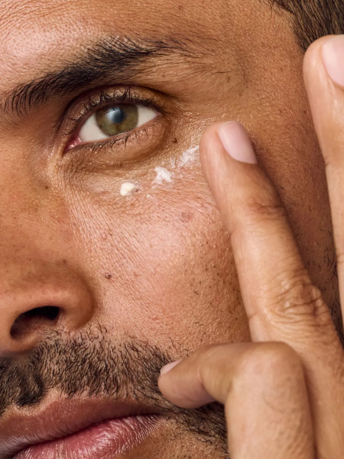 Man applying eye cream