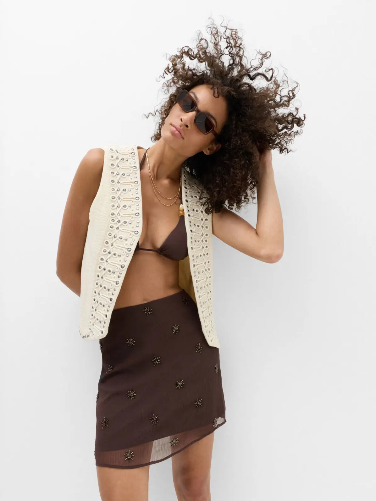 Woman wearing brown skirt and cream gilet 