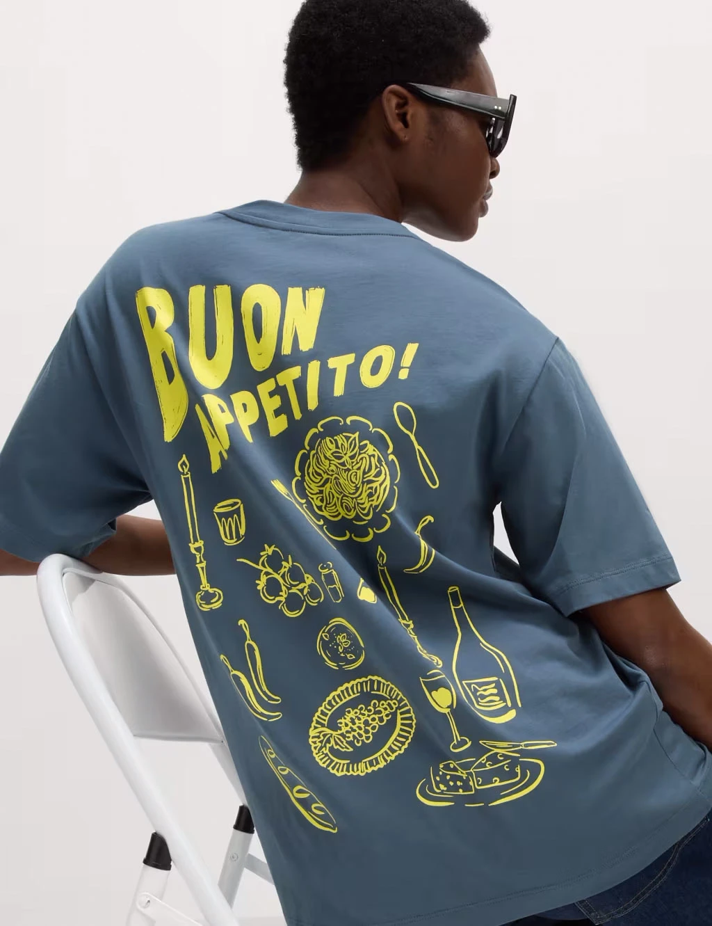Woman wearing blue and yellow graphic oversized T-shirt