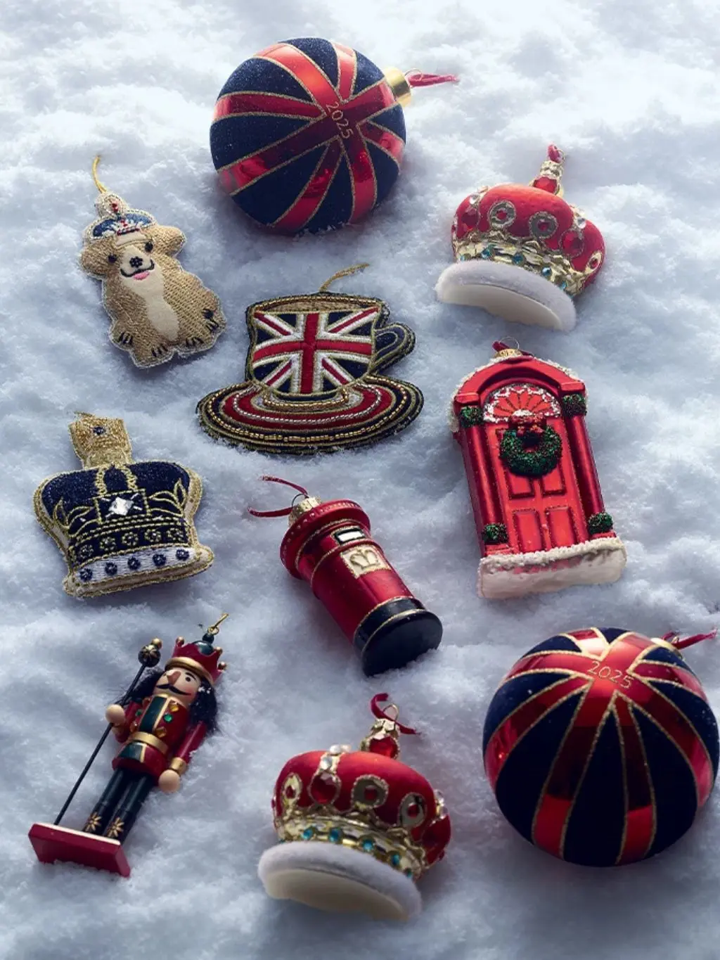 A line up of Christmas baubles sat on snow