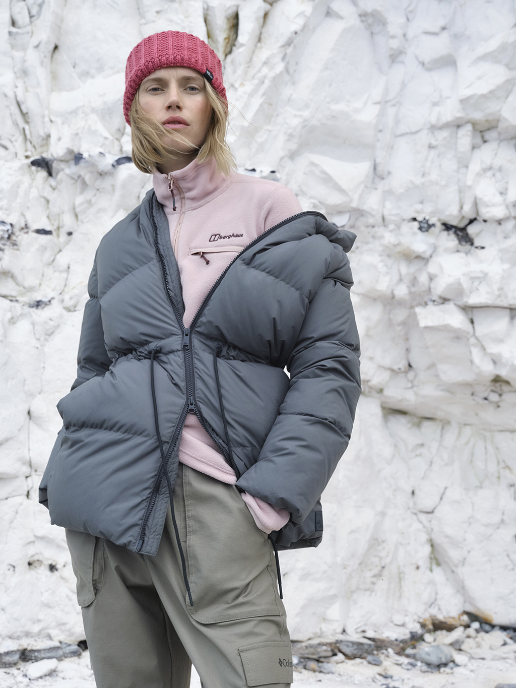 Woman wearing puffer jacket, fleece and beanie hat