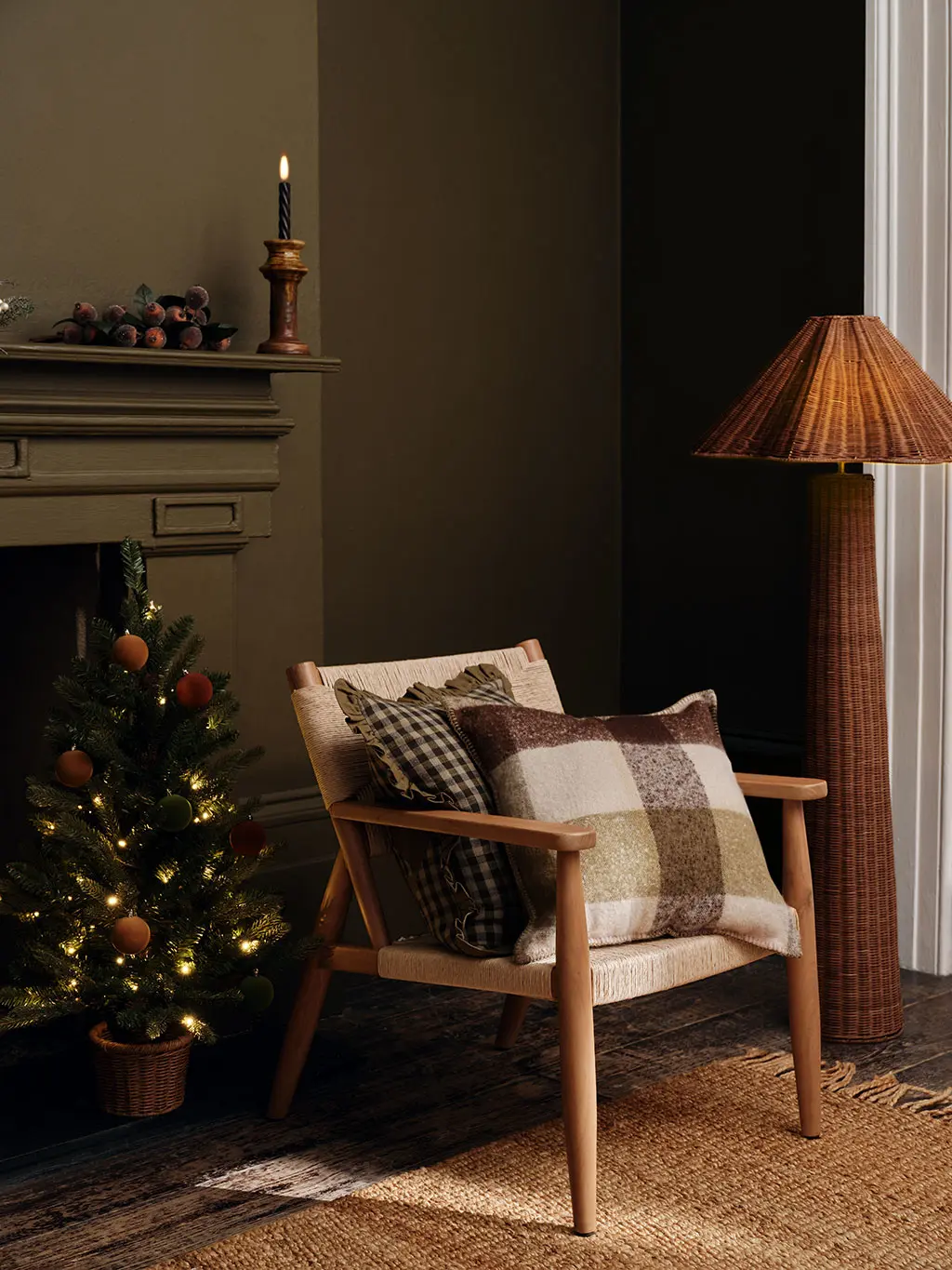 Checked cushions on a neutral arm chair next to a Christmas tree