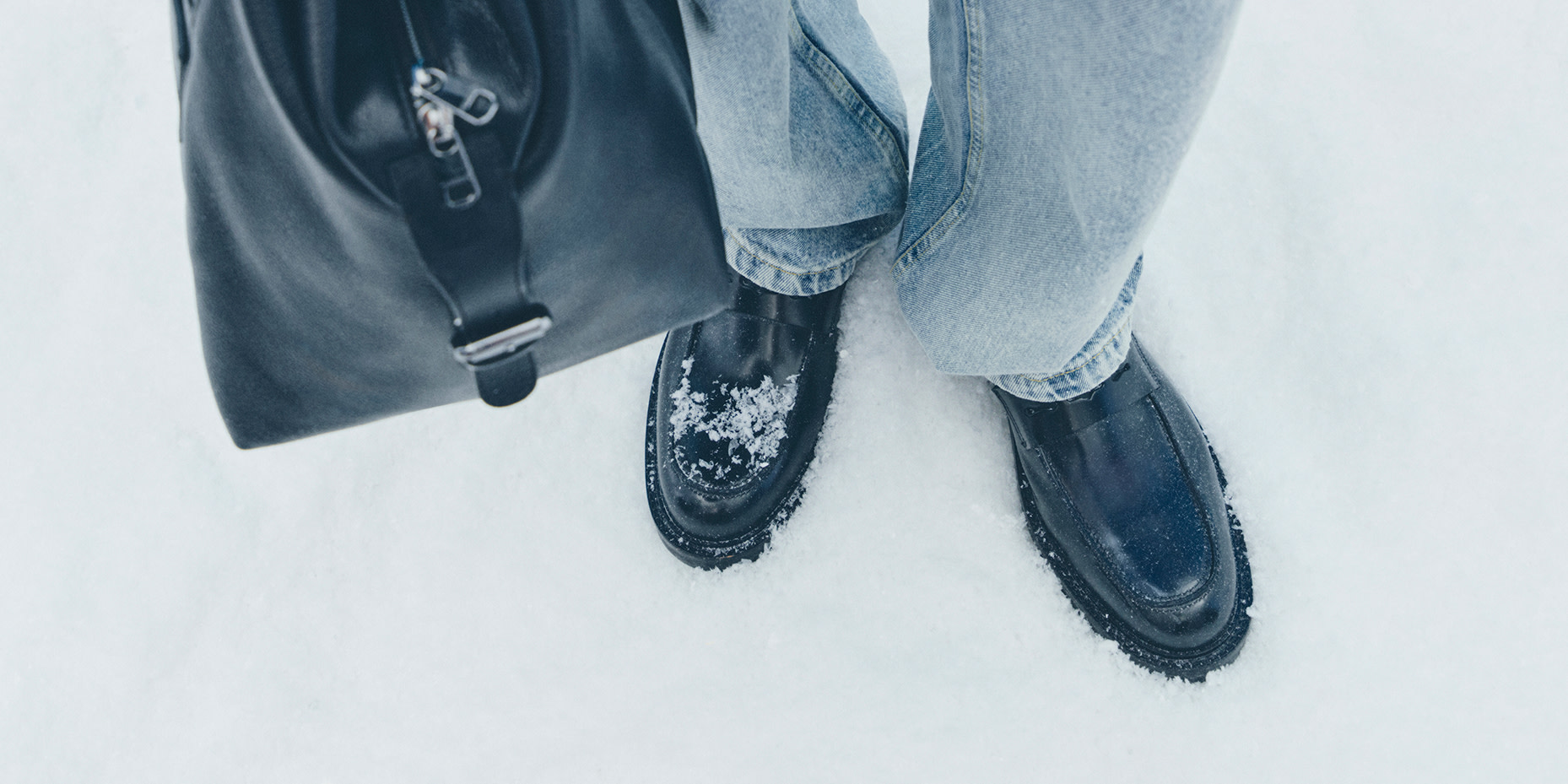 Man wearing black boots in the snow