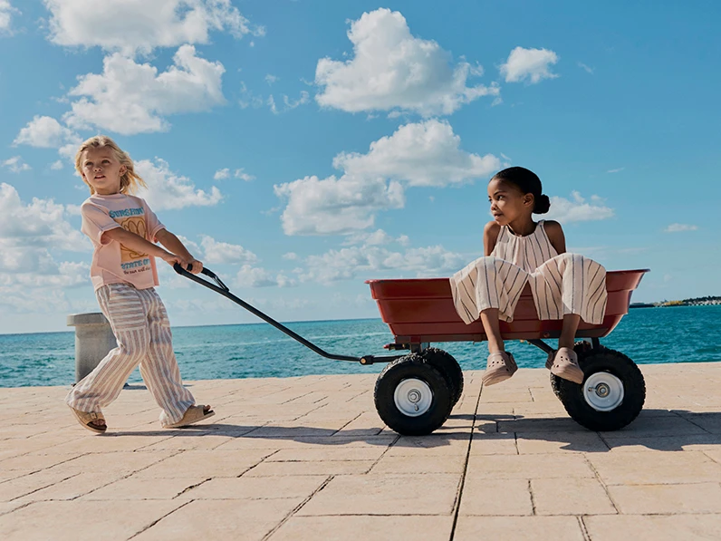 Kids in summer clothing by the sea