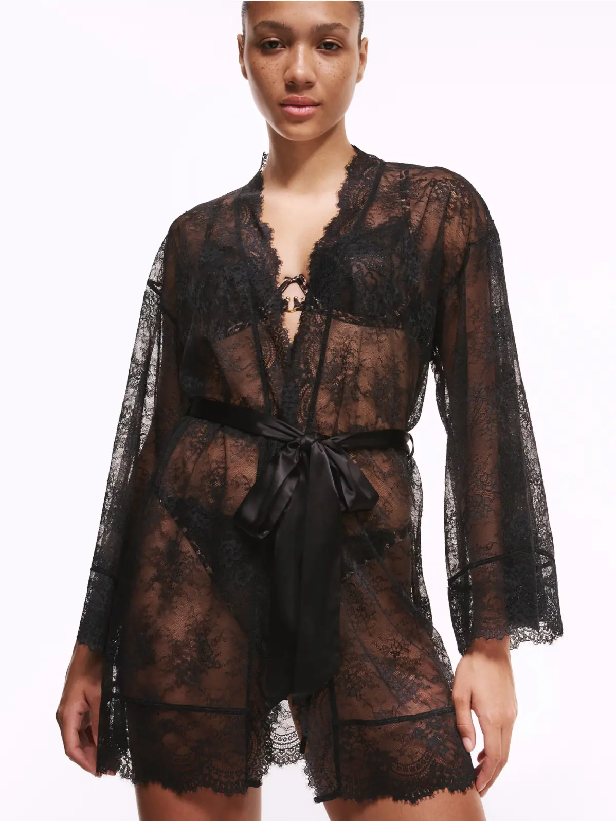 Woman wearing black sheer lace robe with satin tie 