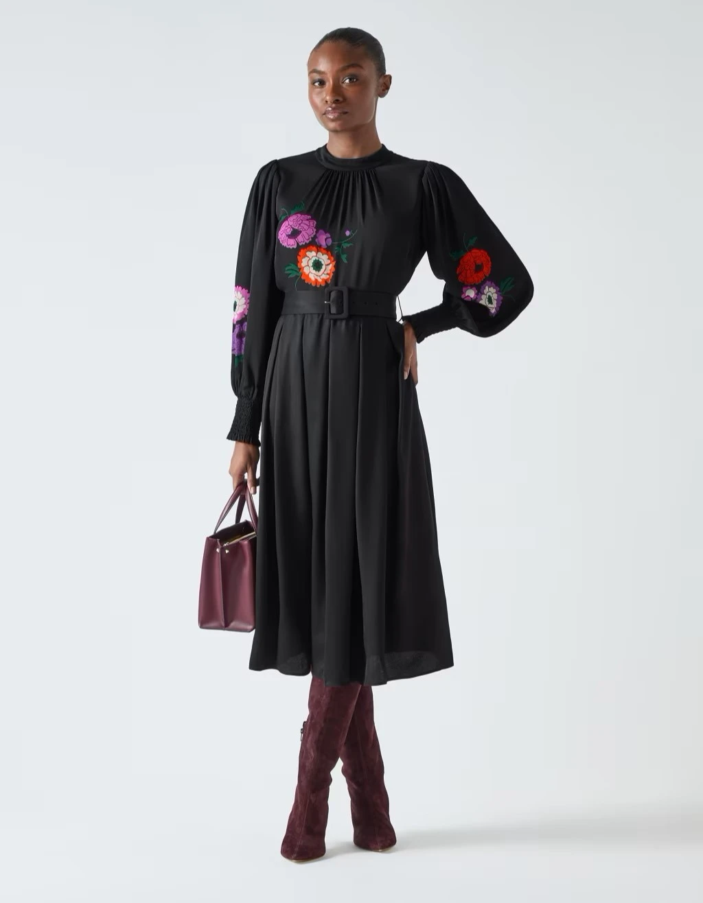 Woman wearing floral LK Bennett dress at M&S