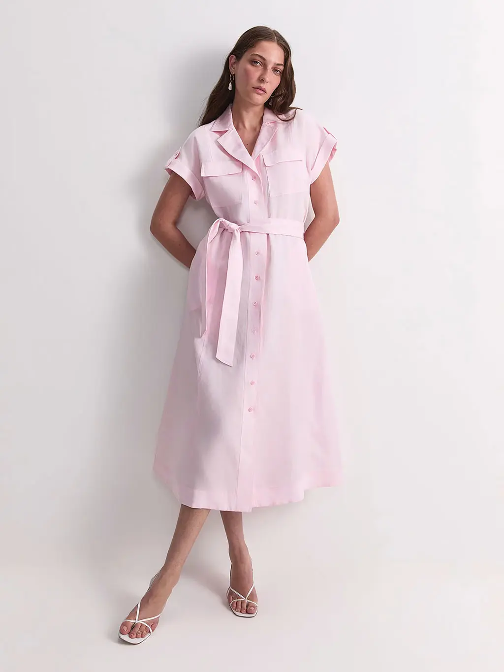 Woman wearing a pink shirt dress with cream heels