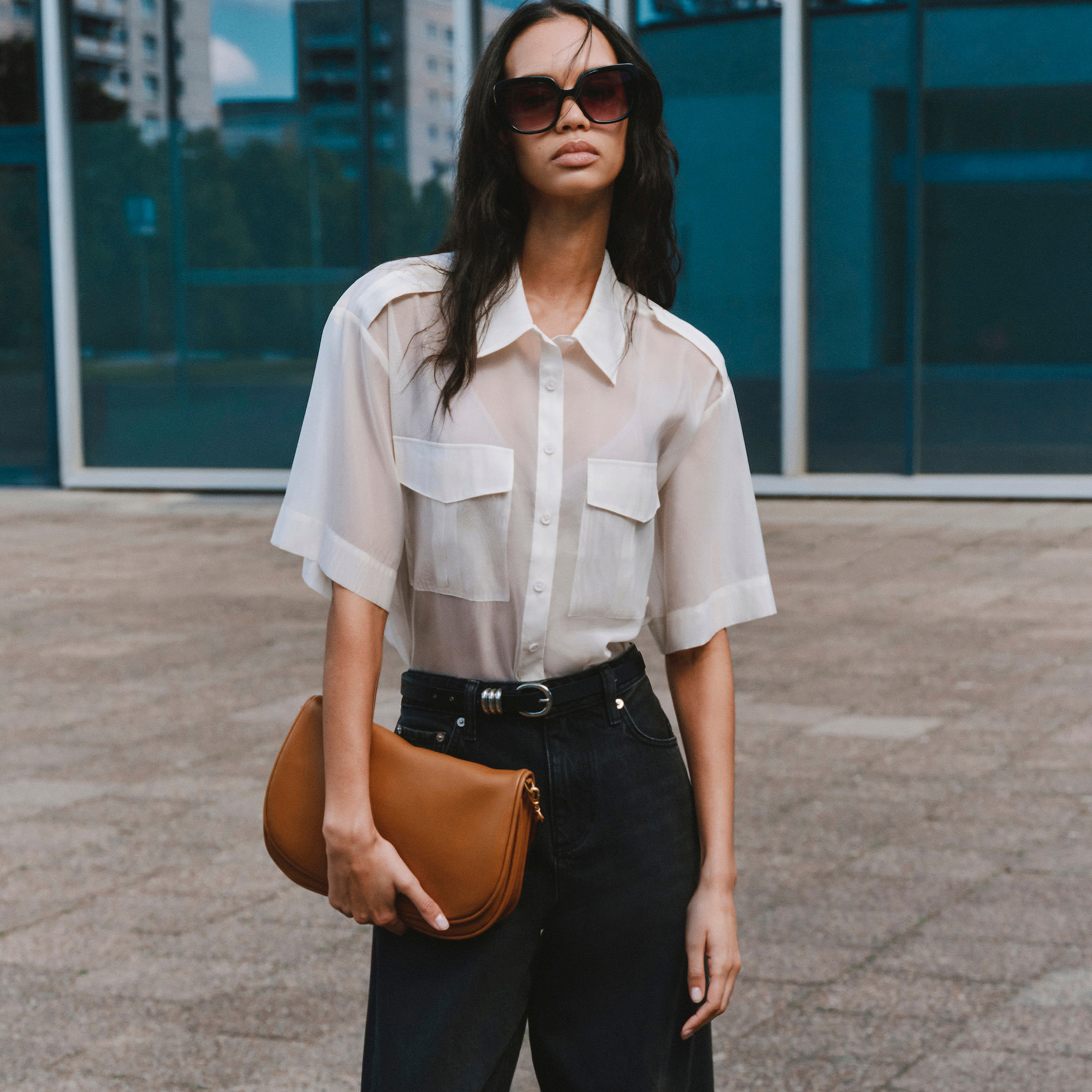 Woman wearing white shirt and black trousers