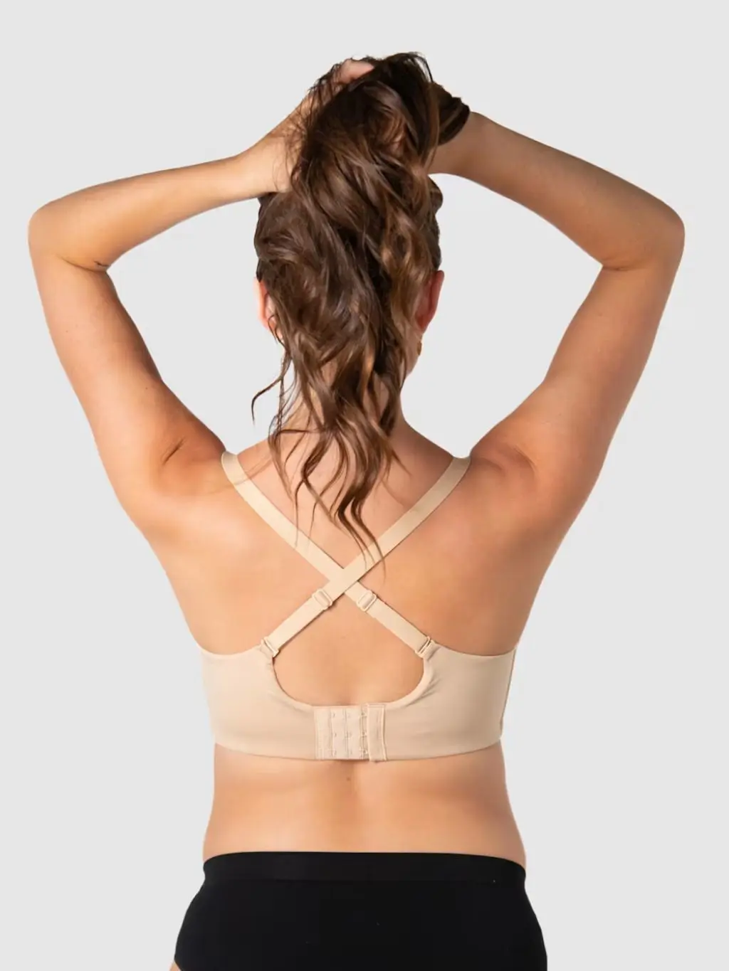 The backshot of a woman in a nursing bra with extra support for larger busts