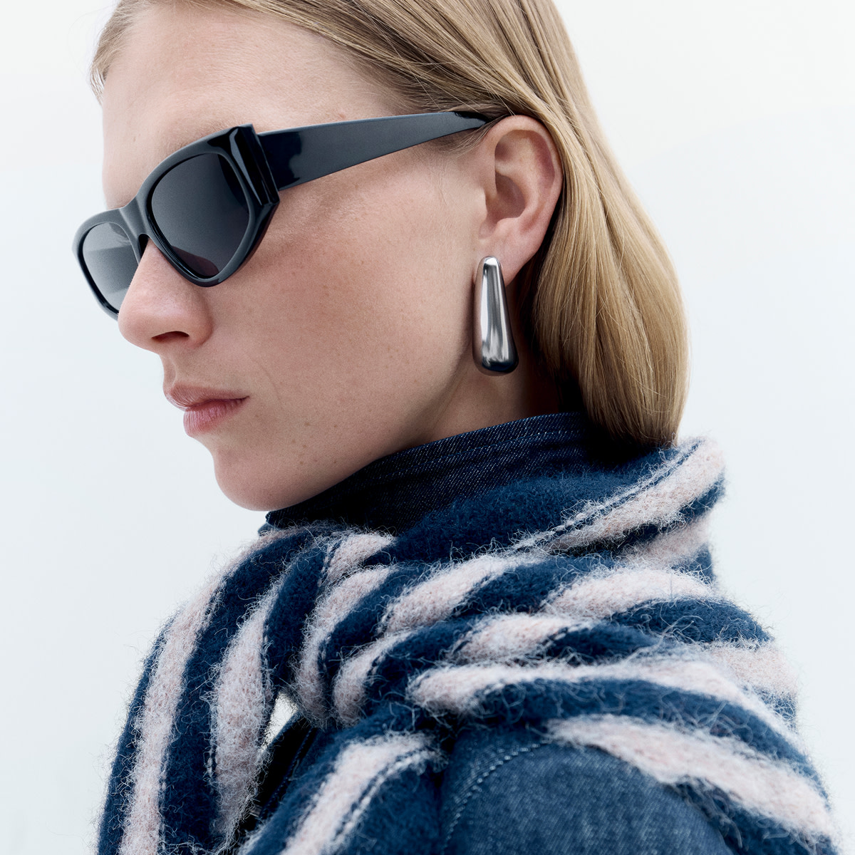 Woman wearing a blue coat and scarf