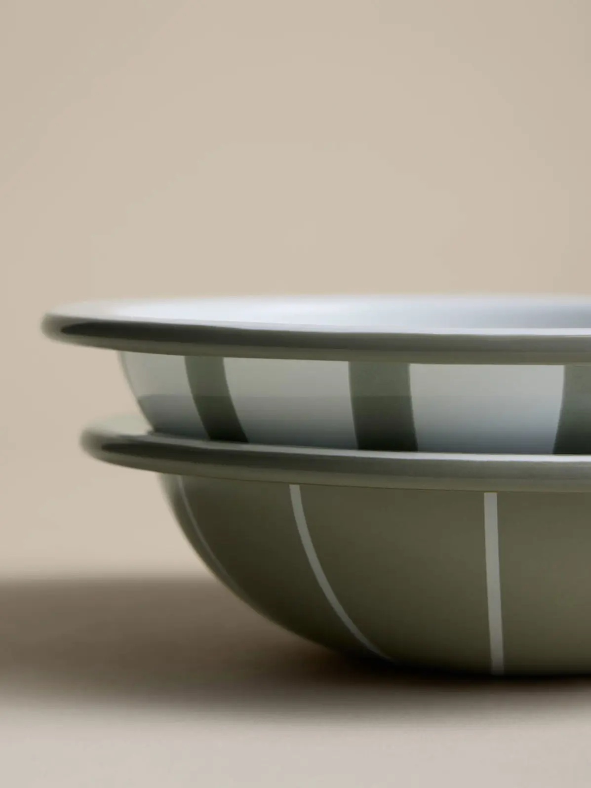 Two green and white striped bowls