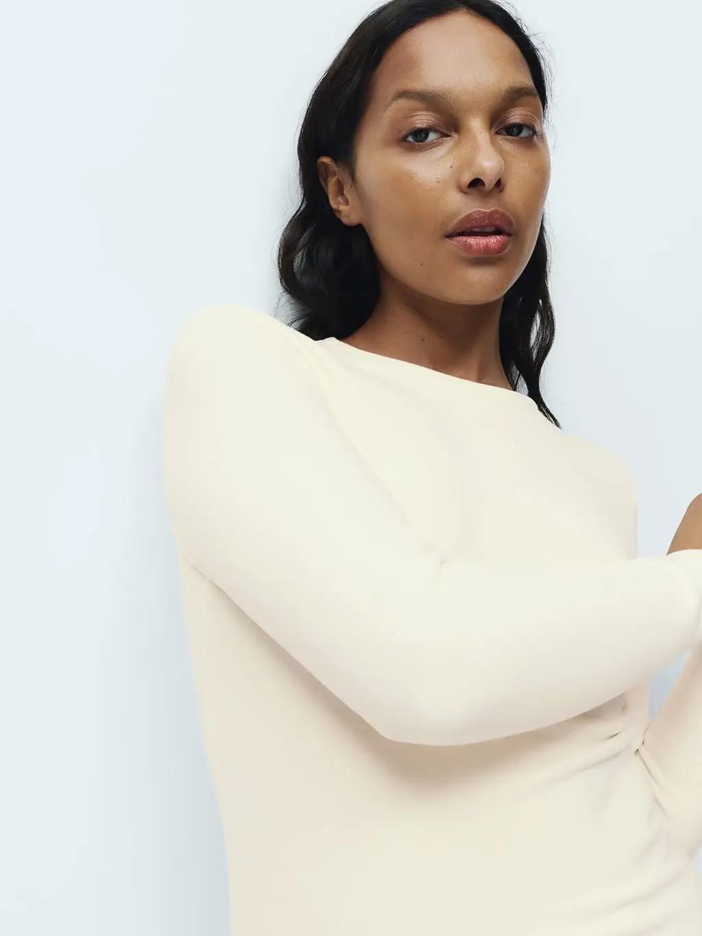 Woman wearing light cream thermal fleece top