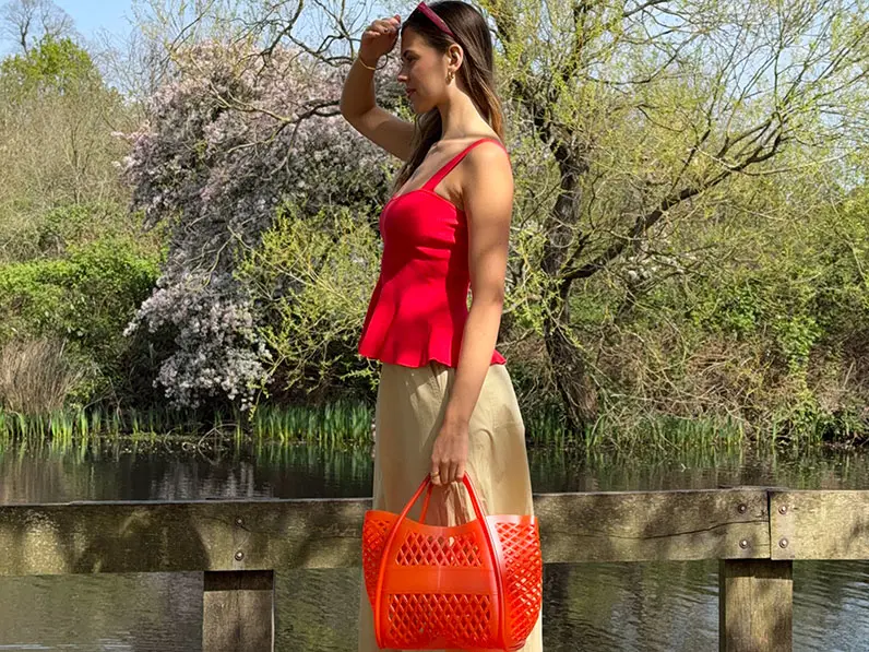 Woman in red top and khaki skirt
