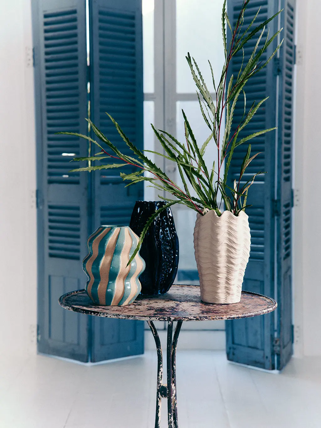 Coastal-themed vases against a rustic backdrop