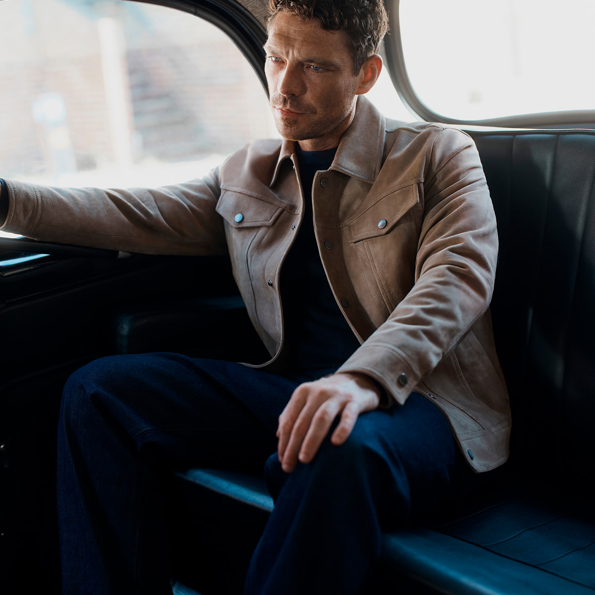 James wearing brown jacket