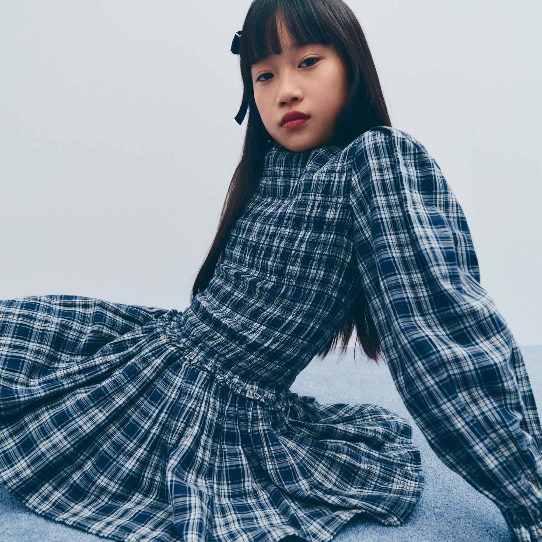 Girl wearing blue checked dress