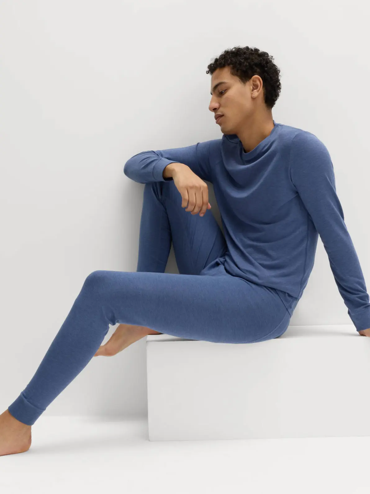 Man wearing blue thermal long-sleeve top and matching long johns