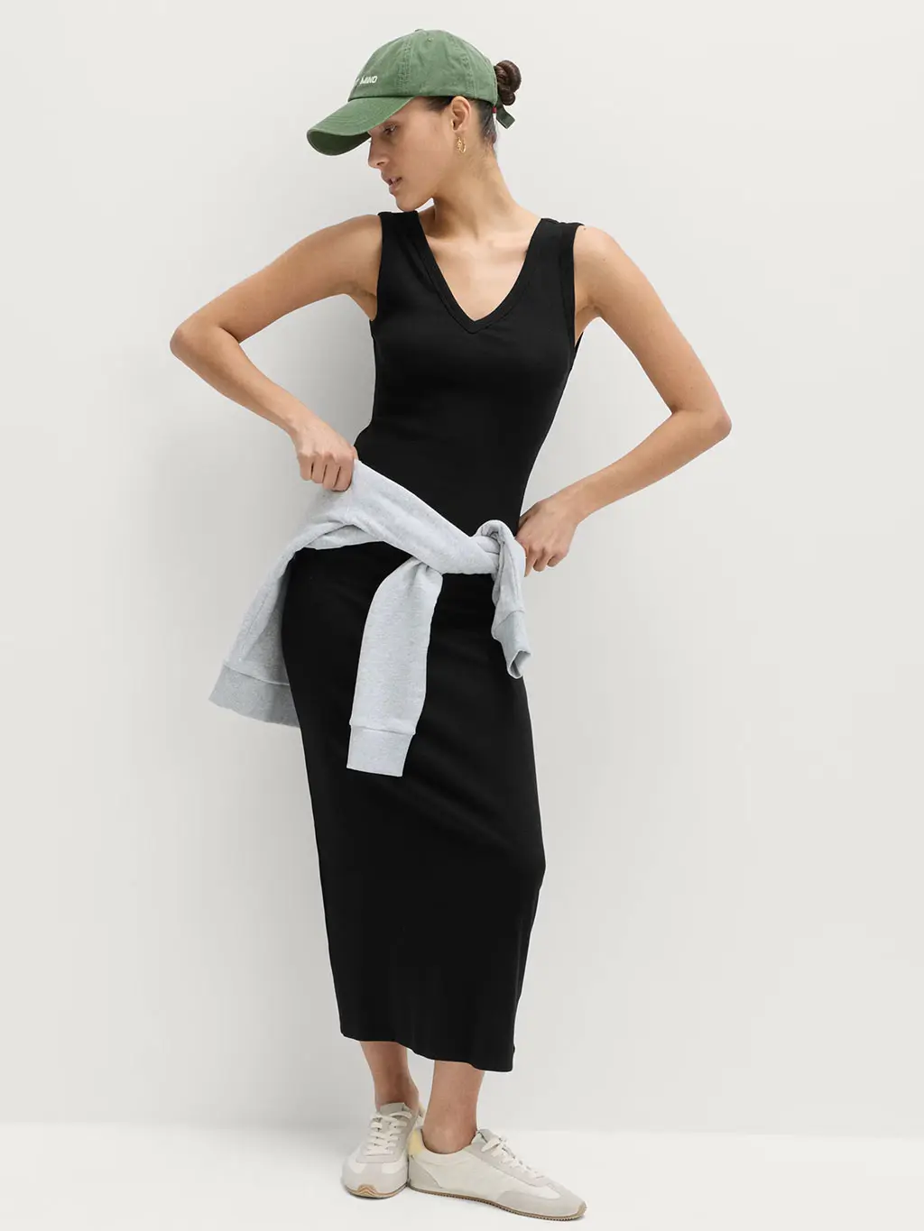 Woman in black dress and trainers