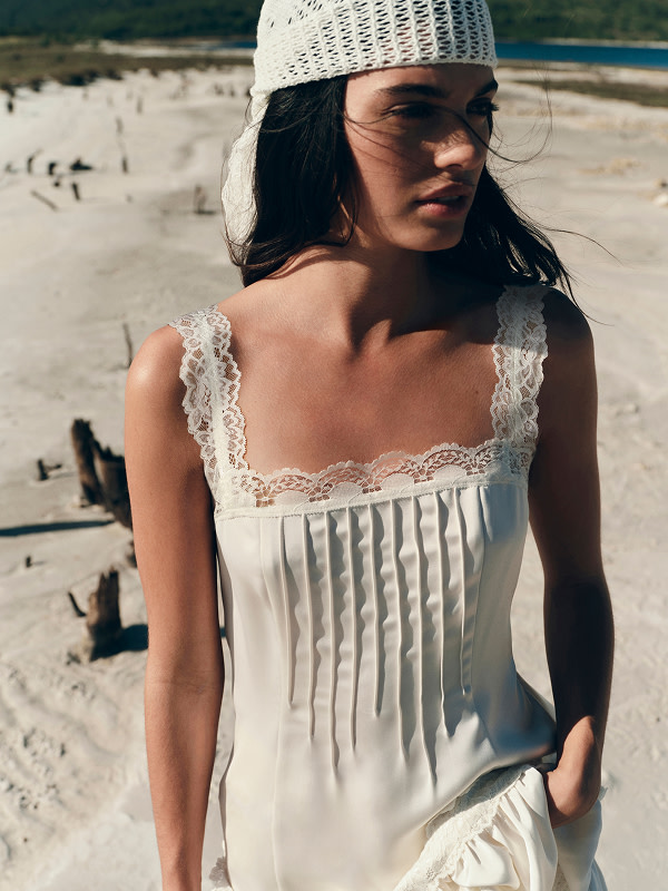 Woman in white dress with headscarf