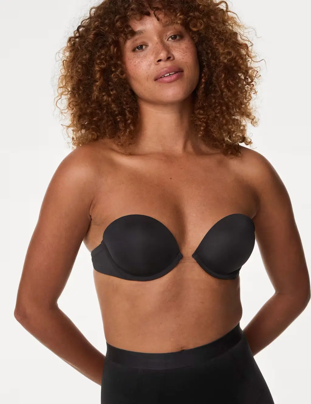 Woman wearing black strapless bra