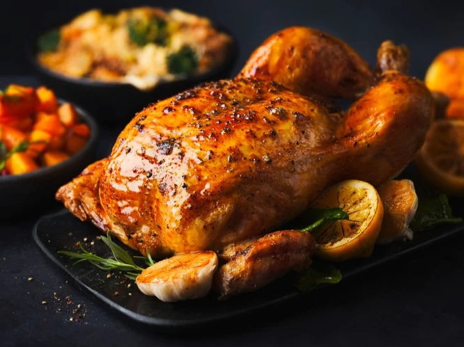 Roast chicken on black platter