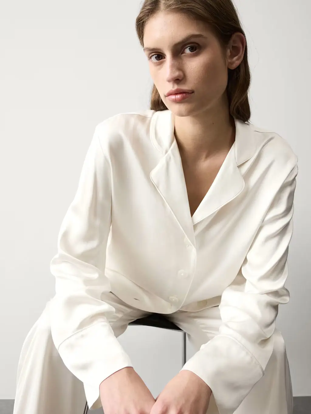 Woman wearing an ivory satin pyjama set