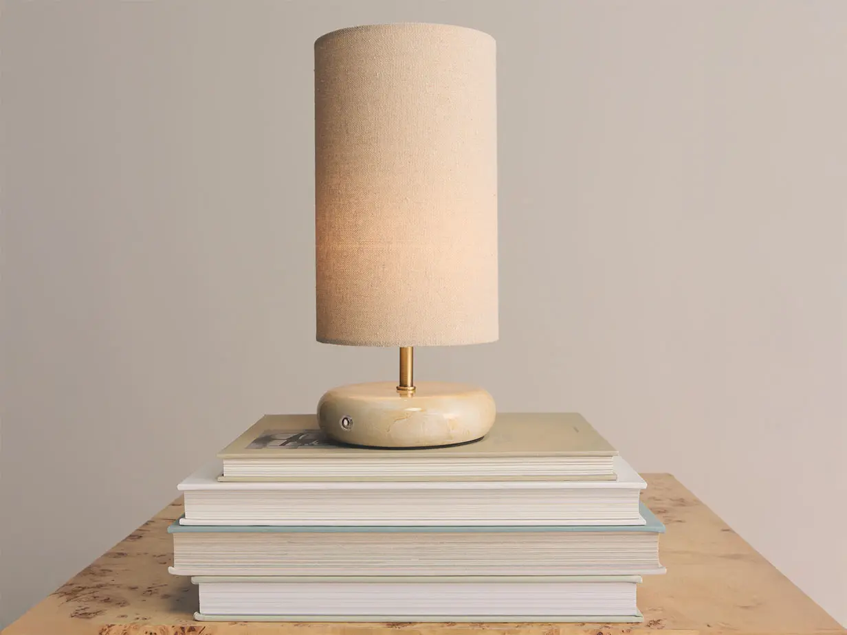 Table lamp sitting on pile of books