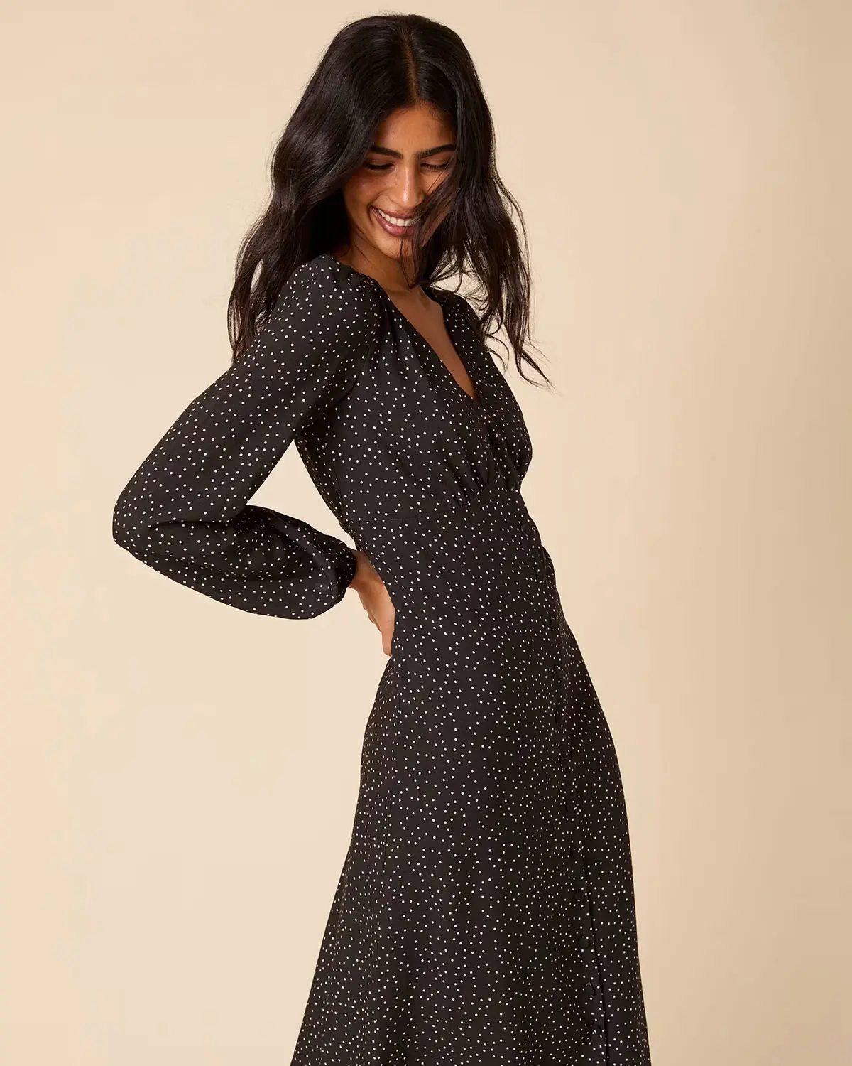 Woman wearing black polka dot dress by Nobody's Child