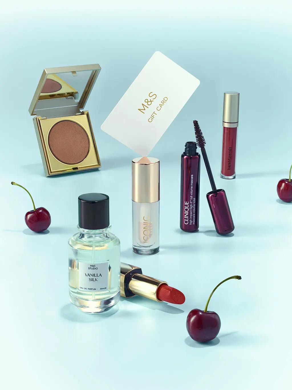 Group of Christmas gifts including perfume, make-up and gift cards.