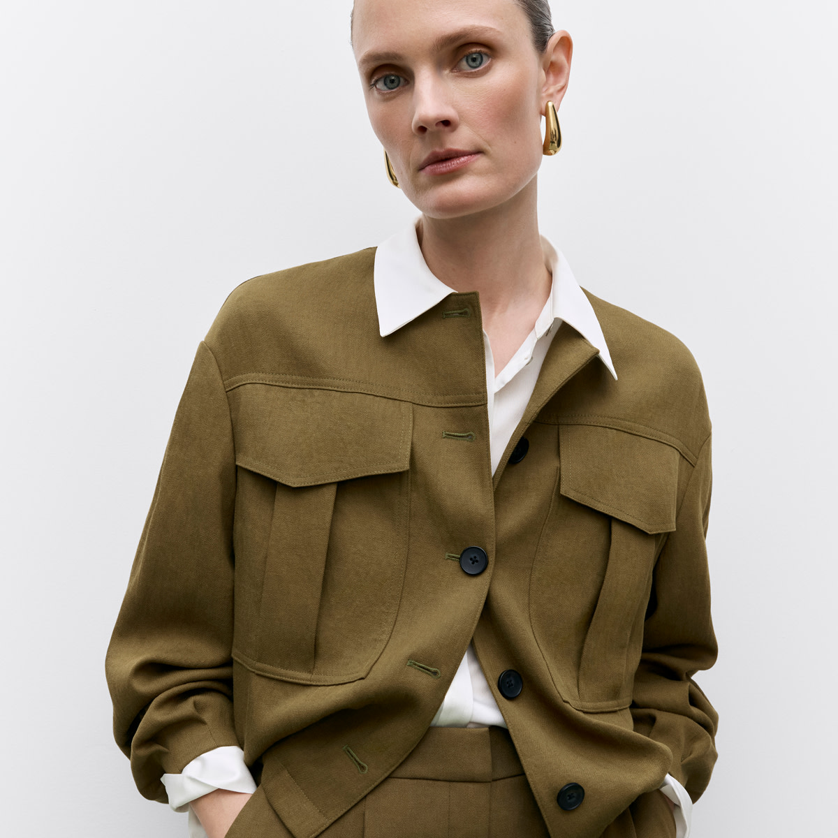 Woman wearing utility-style jacket in khaki