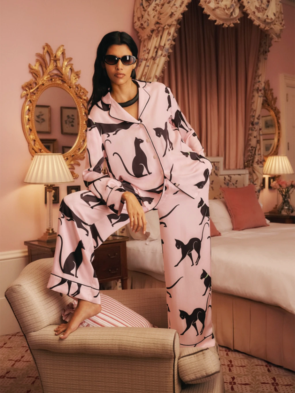 Woman wearing pink pyjamas by M&S X Olivia von Halle