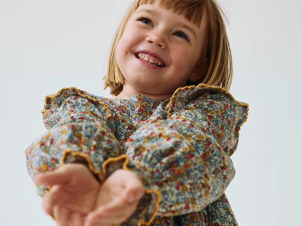 Girl wearing floral blouse from the M&S x Binky collection