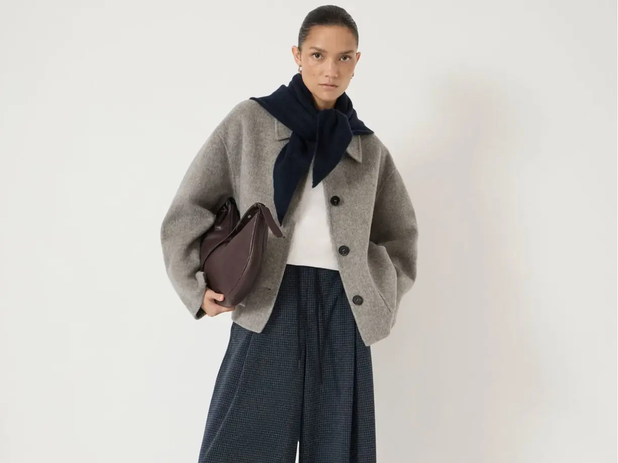 Woman wearing a grey jacket and navy culottes