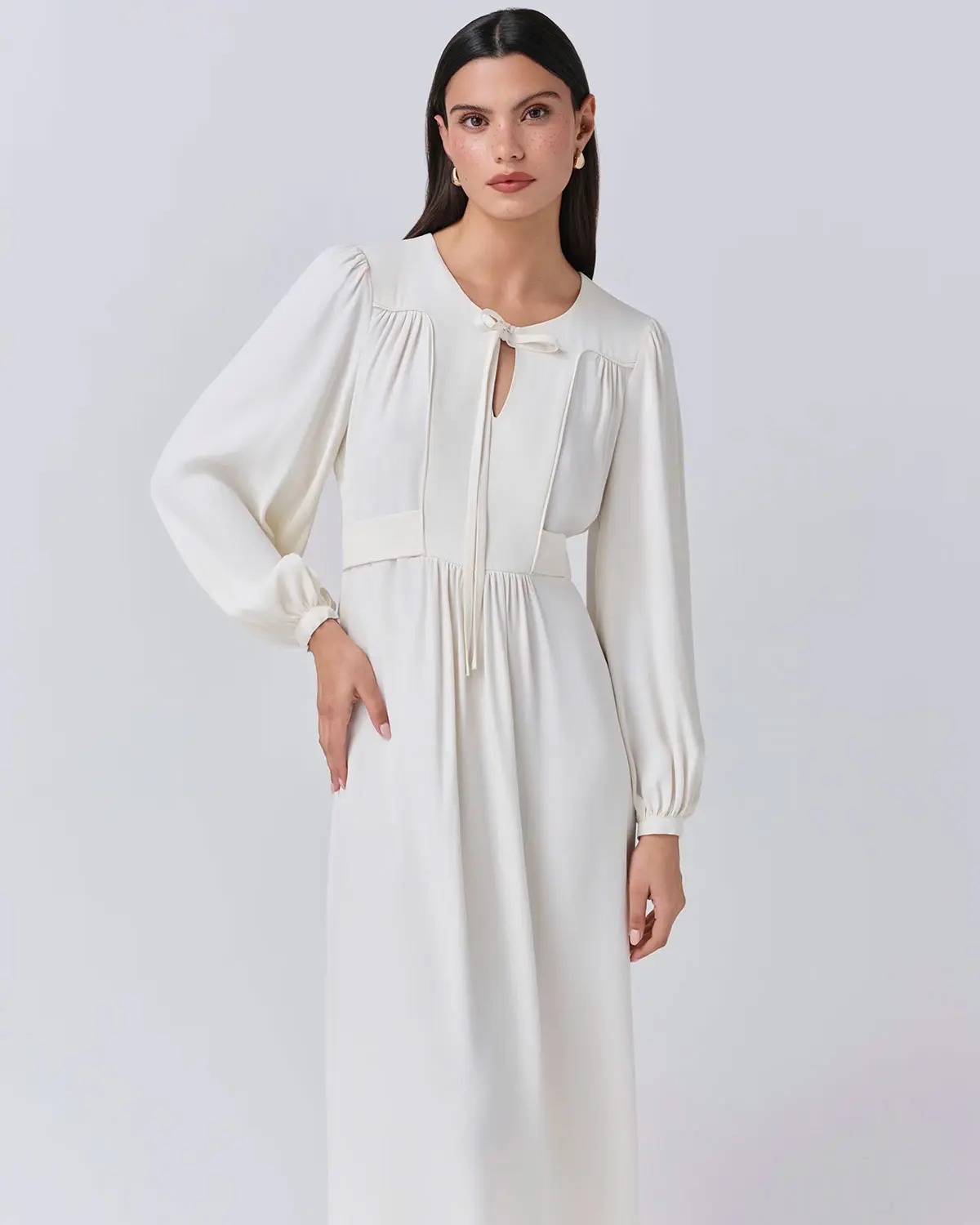 Woman wearing white crepe dress by Ghost